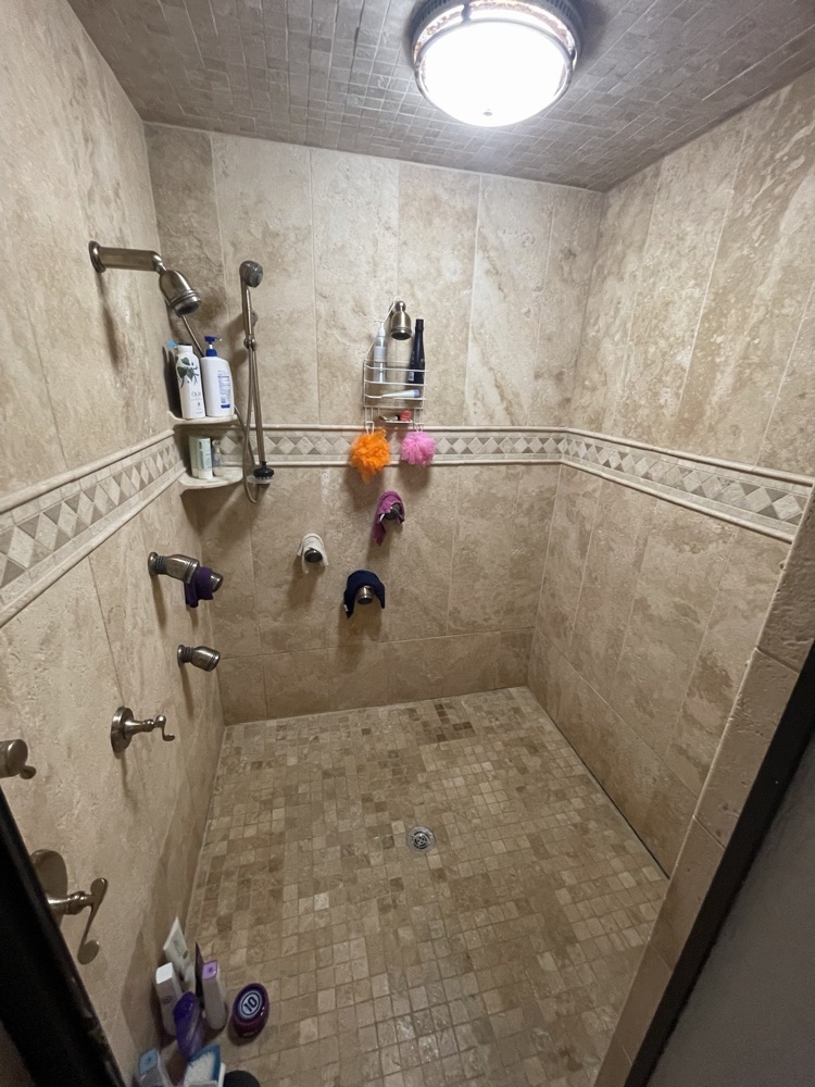 Before: dated tile shower